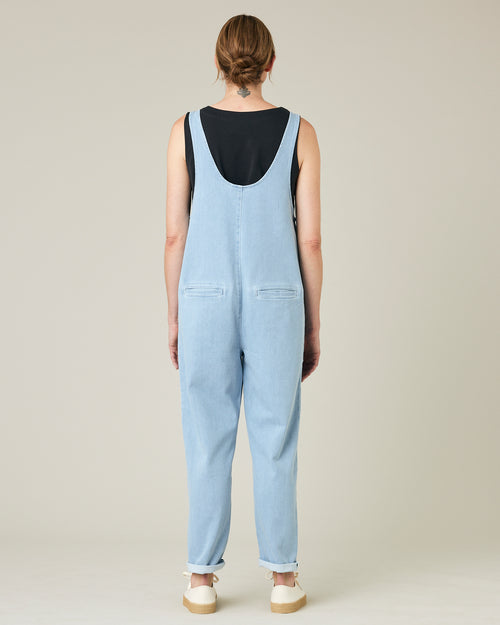 model wears light wash denim lola jumpsuit 