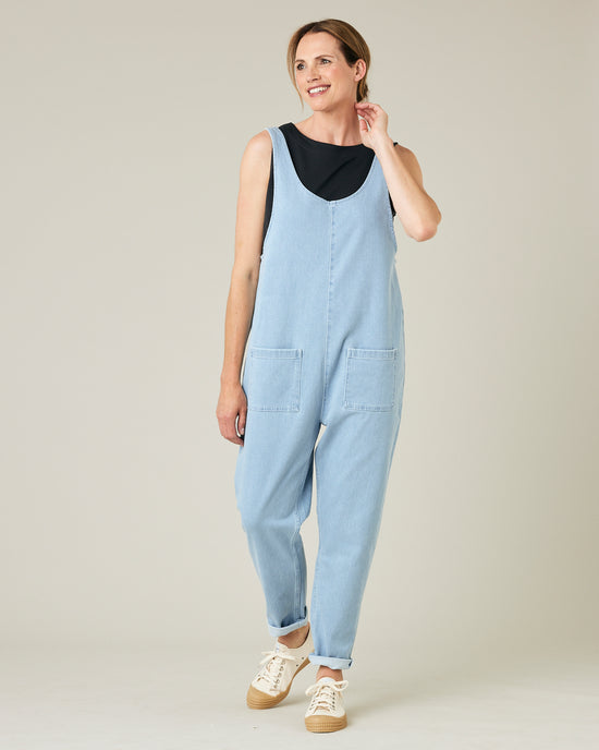 model wears light wash denim lola jumpsuit 