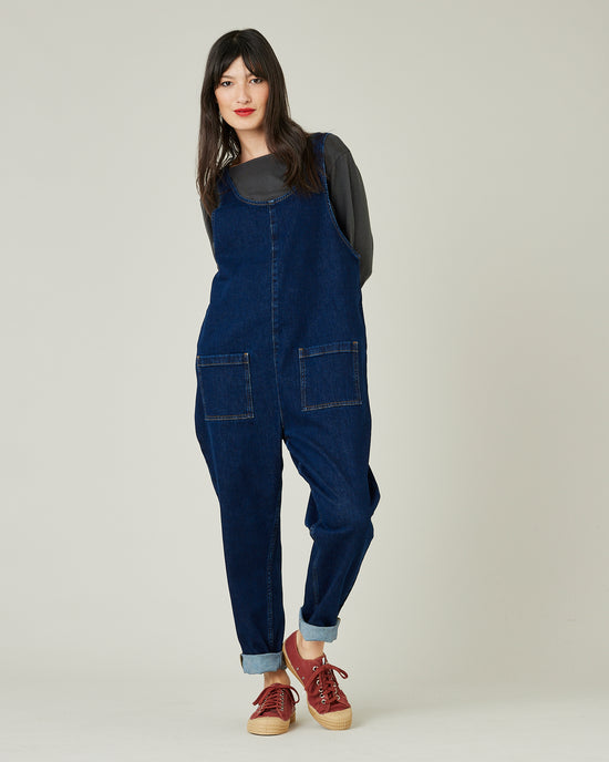 model wears dark wash denim lola jumpsuit