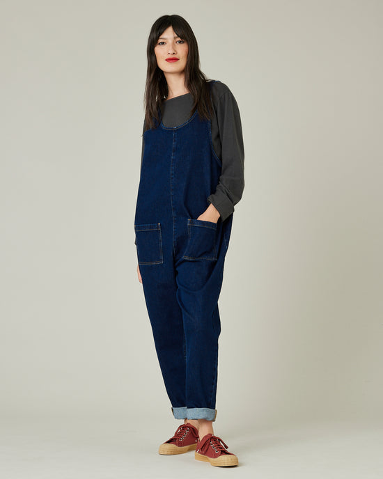 model wears dark wash denim lola jumpsuit