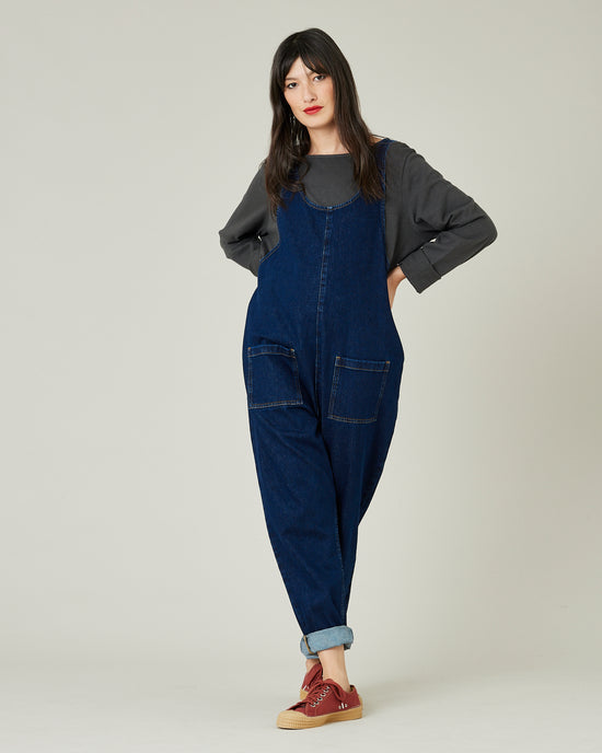 model wears dark wash denim lola jumpsuit