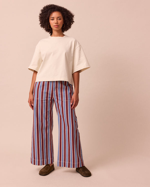 model wears luca burgundy and sky stripe denim trousers right