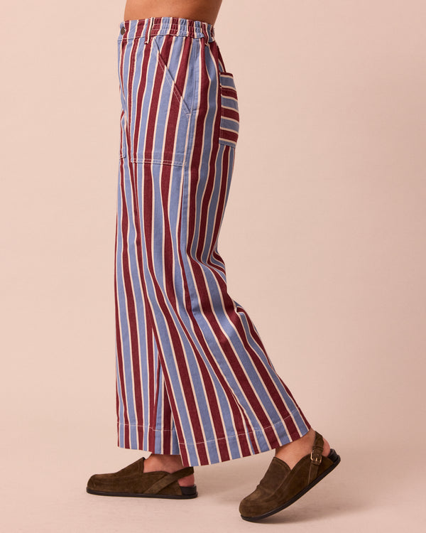 model wears luca burgundy and sky stripe denim trousers left