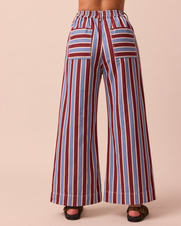 model wears luca burgundy and sky stripe denim trousers back