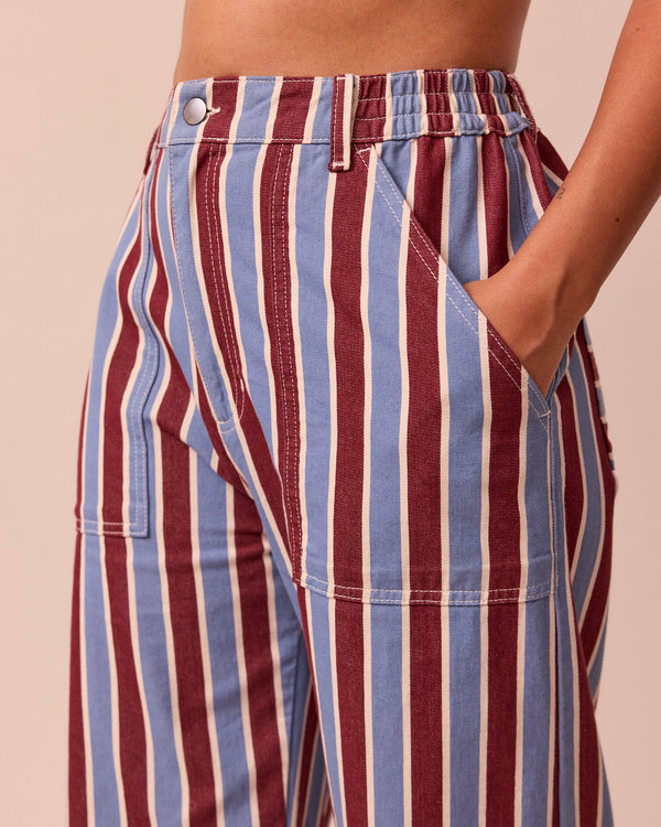 model wears luca burgundy and sky stripe denim trousers