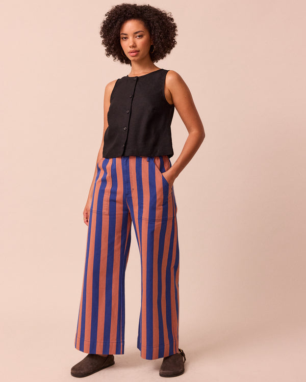 model wears luca cobalt and terracotta stripe denim trousers right