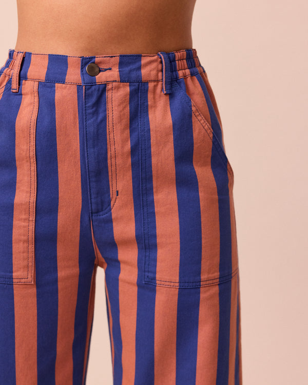 model wears luca cobalt and terracotta stripe denim trousers