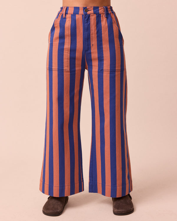 model wears luca cobalt and terracotta stripe denim trousers front