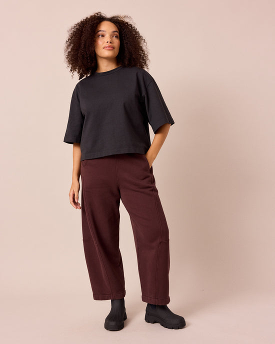 model wears lyra black cherry fleeceback jersey trousers left