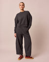 model wears lyra charcal fleeceback jersey trousers left
