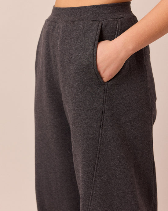 model wears lyra charcal fleeceback jersey trousers right