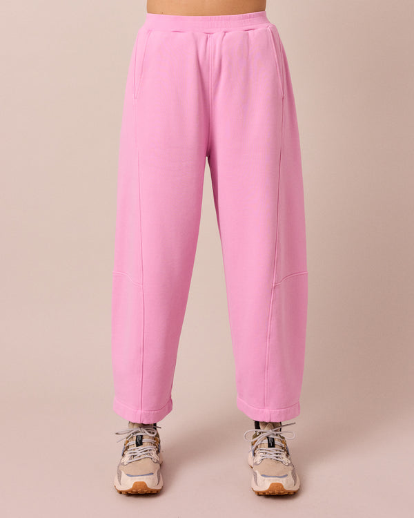 model wears lyra washed pink jersey trousers front
