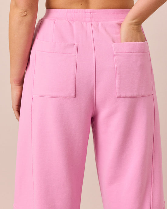 model wears lyra washed pink jersey trousers