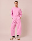 model wears lyra washed pink jersey trousers left
