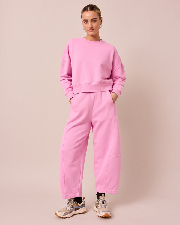model wears lyra washed pink jersey trousers left