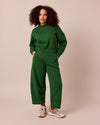 model wears lyra verdant green fleeceback jersey trousers left