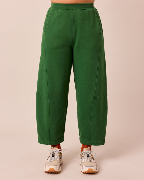 model wears lyra verdant green fleeceback jersey trousers front