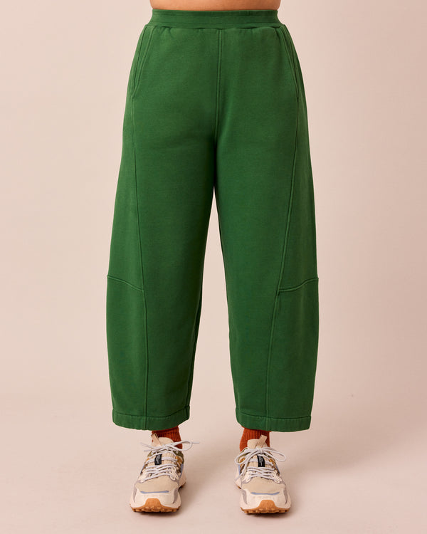 model wears lyra verdant green fleeceback jersey trousers front