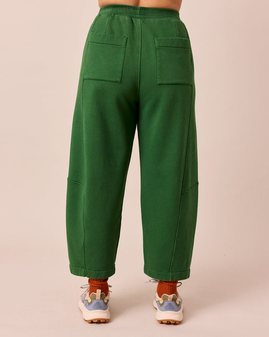 model wears lyra verdant green fleeceback jersey trousers back