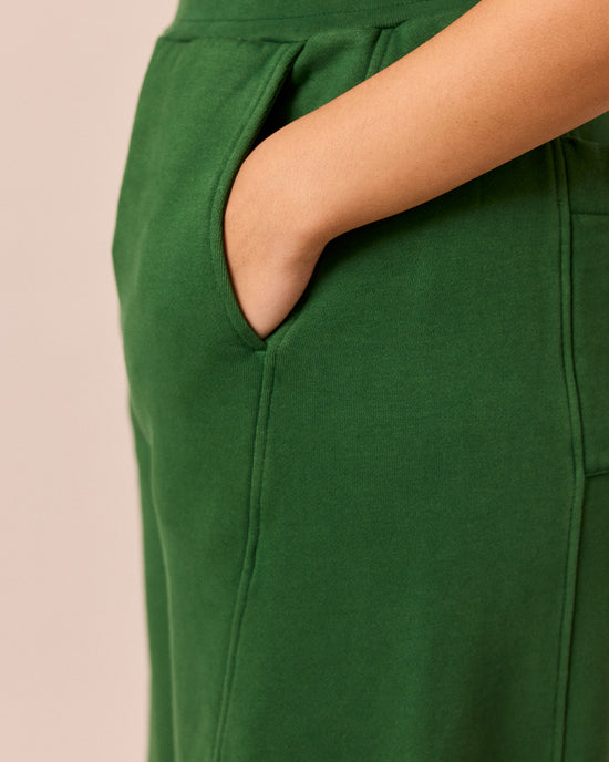 model wears lyra verdant green fleeceback jersey trousers