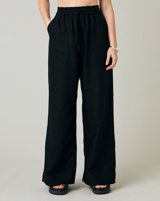 model wears black linen lexi trousers front