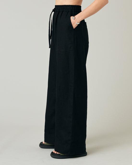 model wears black linen lexi trousers left