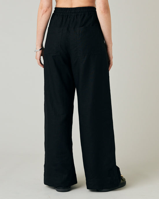 model wears black linen lexi trousers back