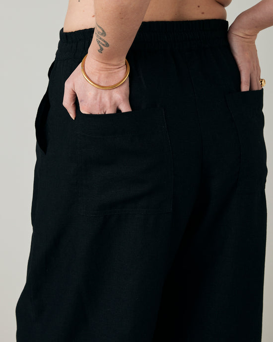 pregnant model wears black linen lexi trousers