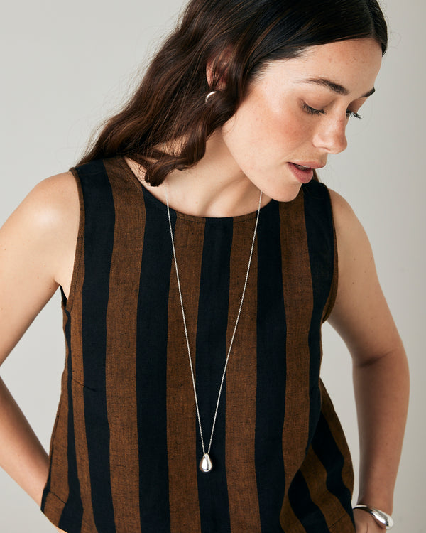 model wears esme linen rust stripe top