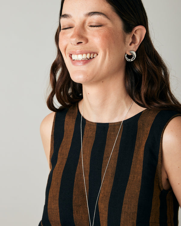 model wears esme linen rust stripe top