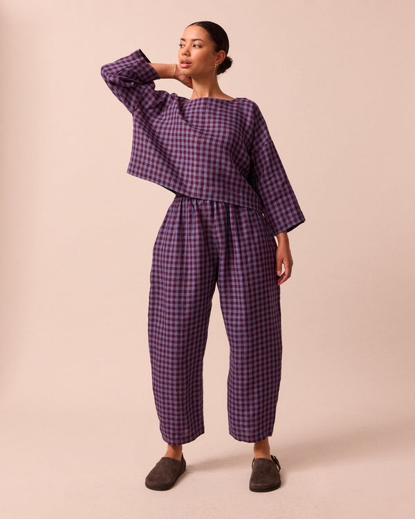 model wears mabel blueberry gingham linen trousers front