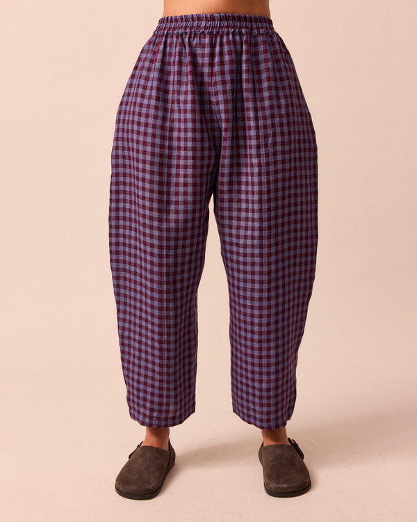 model wears mabel blueberry gingham linen trousers right