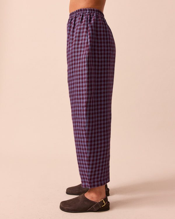 model wears mabel blueberry gingham linen trousers left