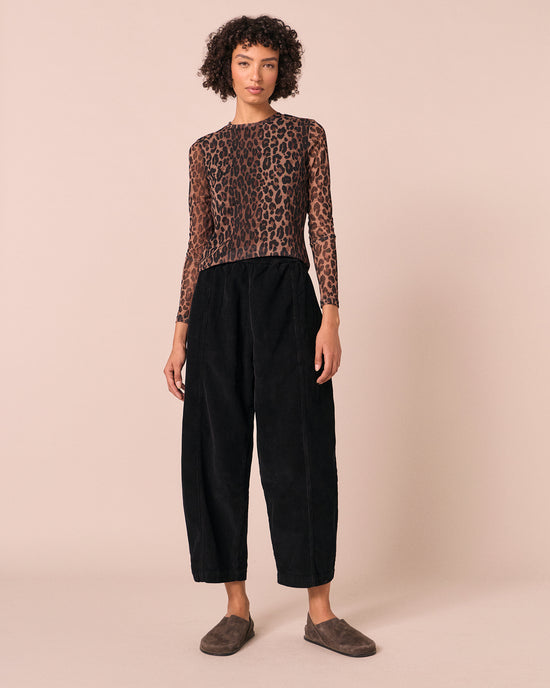 model wears mabel black cord trousers left