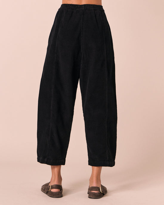 model wears mabel black cord trousers back