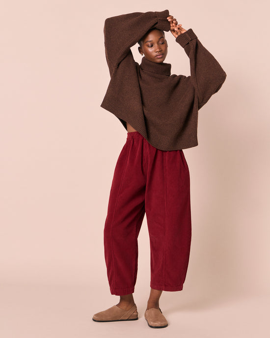 model wears mabel garnet cord trousers right