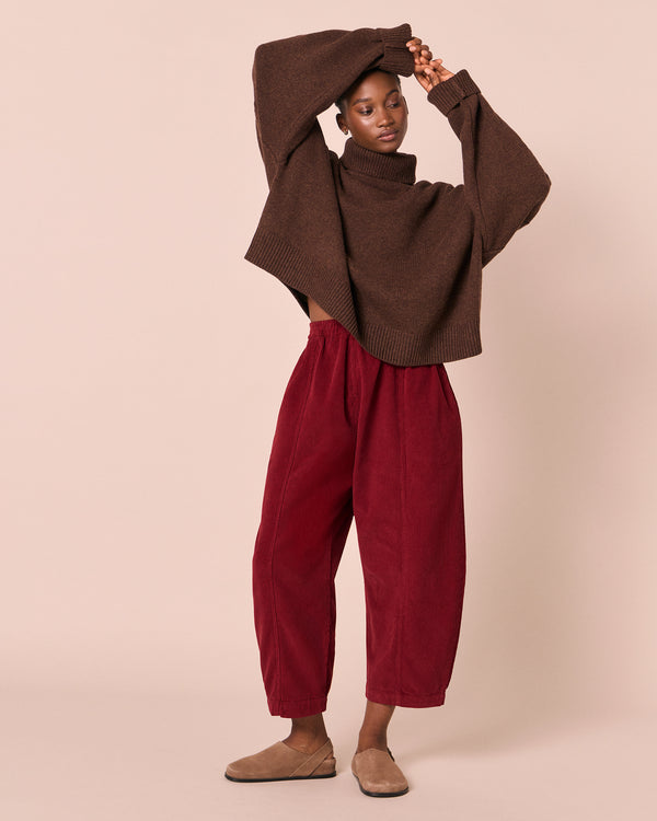 model wears mabel garnet cord trousers right
