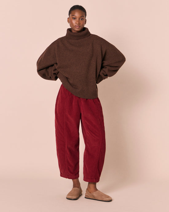 model wears mabel garnet cord trousers left