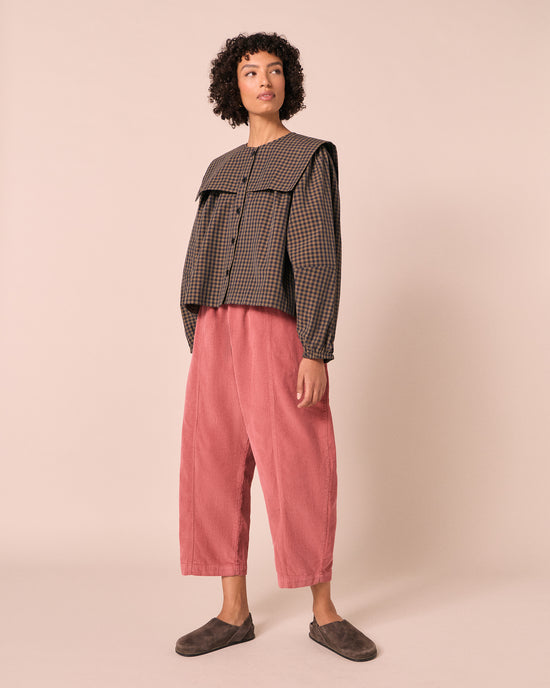 model wears mael parfait pink cord trousers right