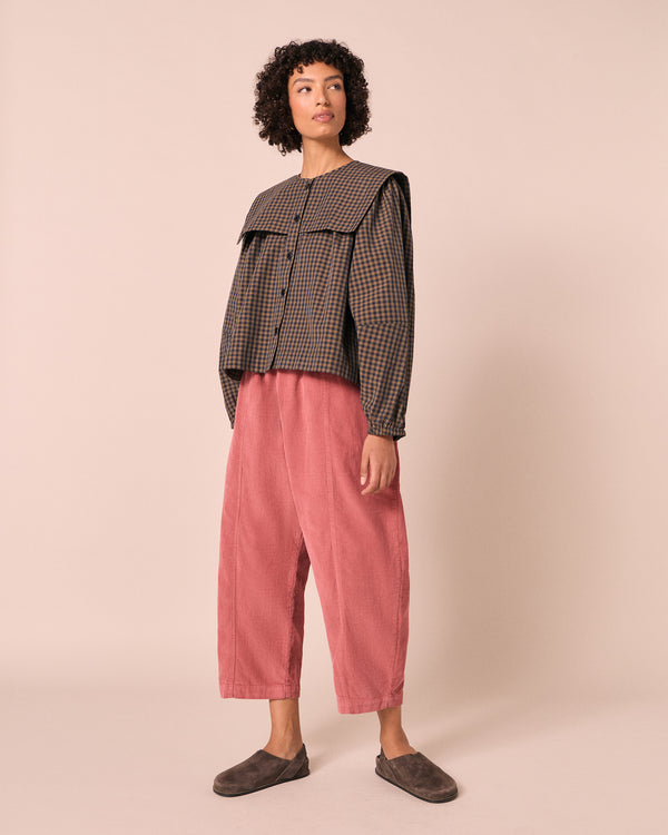 model wears mael parfait pink cord trousers right