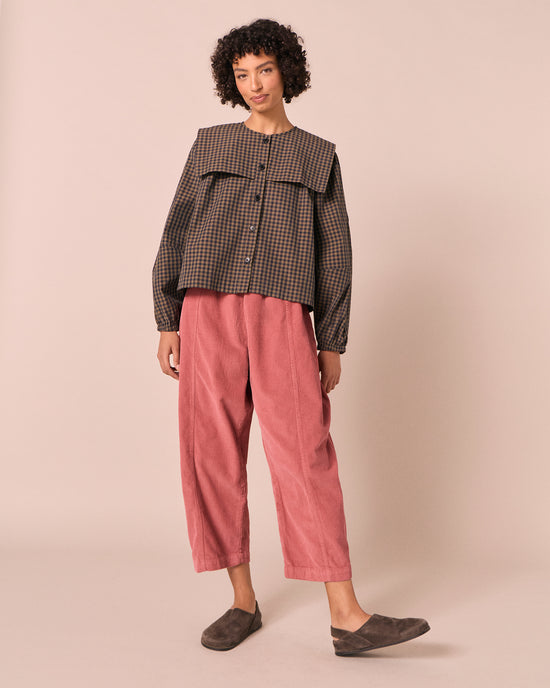 model wears mabel parfait pink cord trousers left
