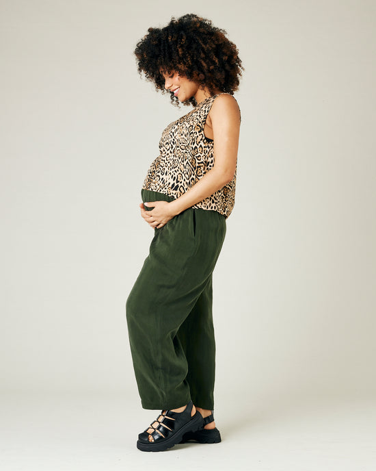 pregnant model wears dark khaki cupro mabel trousers