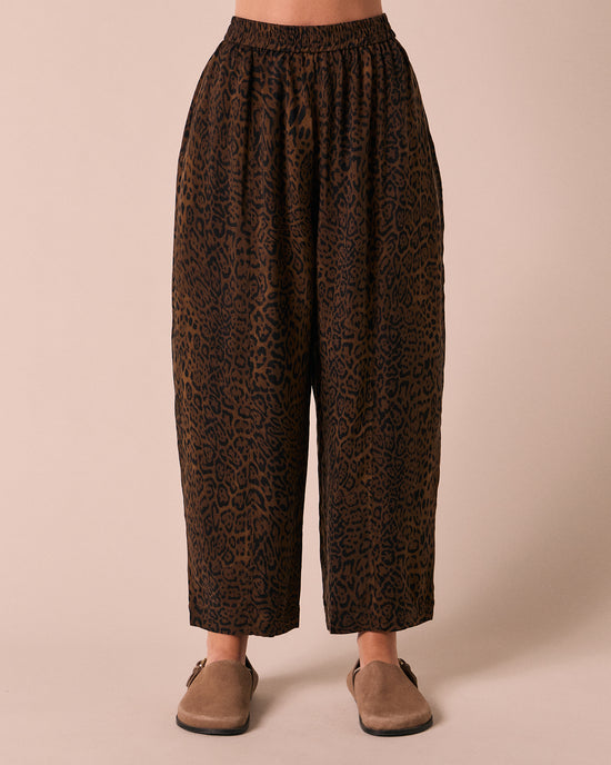 model wears mabel dark leopard cupro trousers front