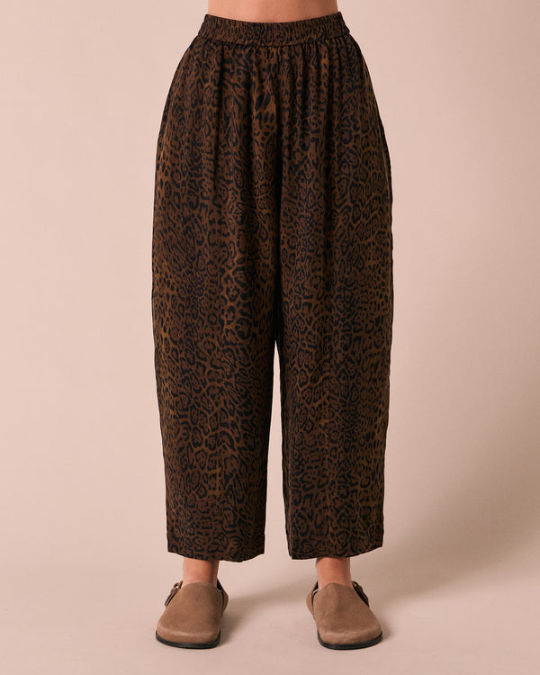 model wears mabel dark leopard cupro trousers front