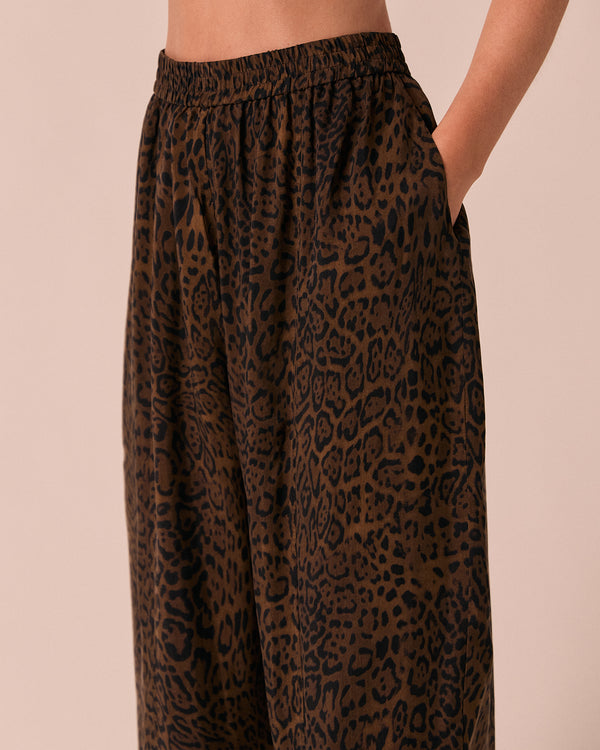 model wears mabel dark leopard cupro trousers left