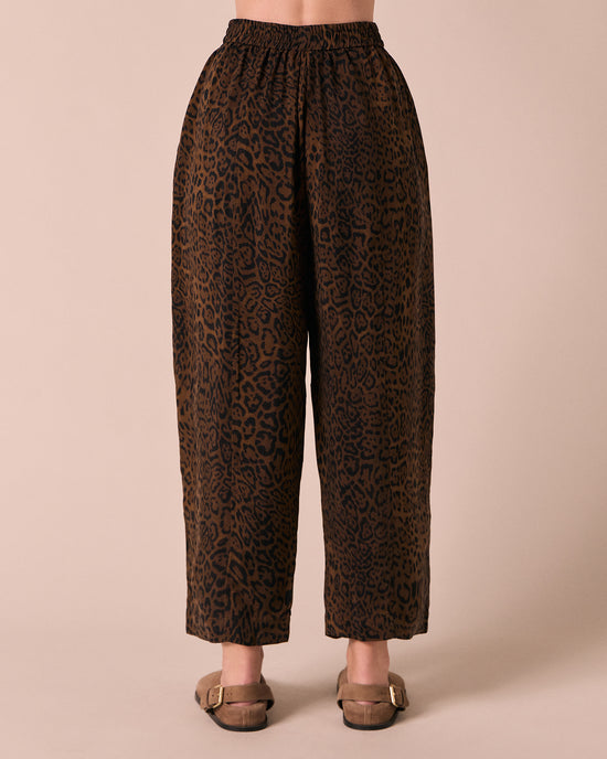model wears mabel dark leopard cupro trousers back