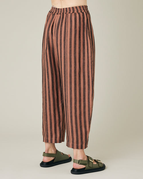 model wears longer length biscuit stripe mabel trousers right