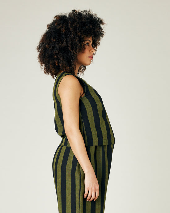 pregnant model wears olive and black stripe linen esme top