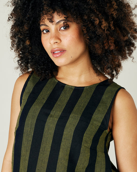 pregnant model wears olive and black stripe linen esme top