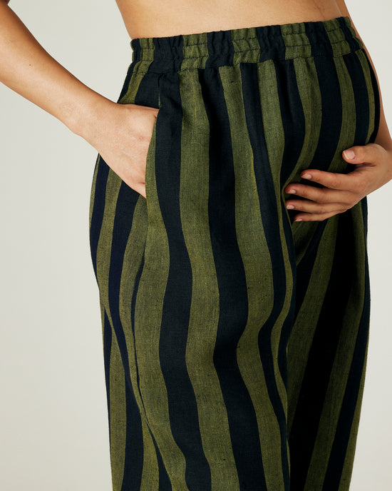 pregnant model wears olive and black stripe linen mabel trousers